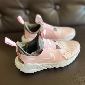 Little girls pink and grey pull on Nike shoes